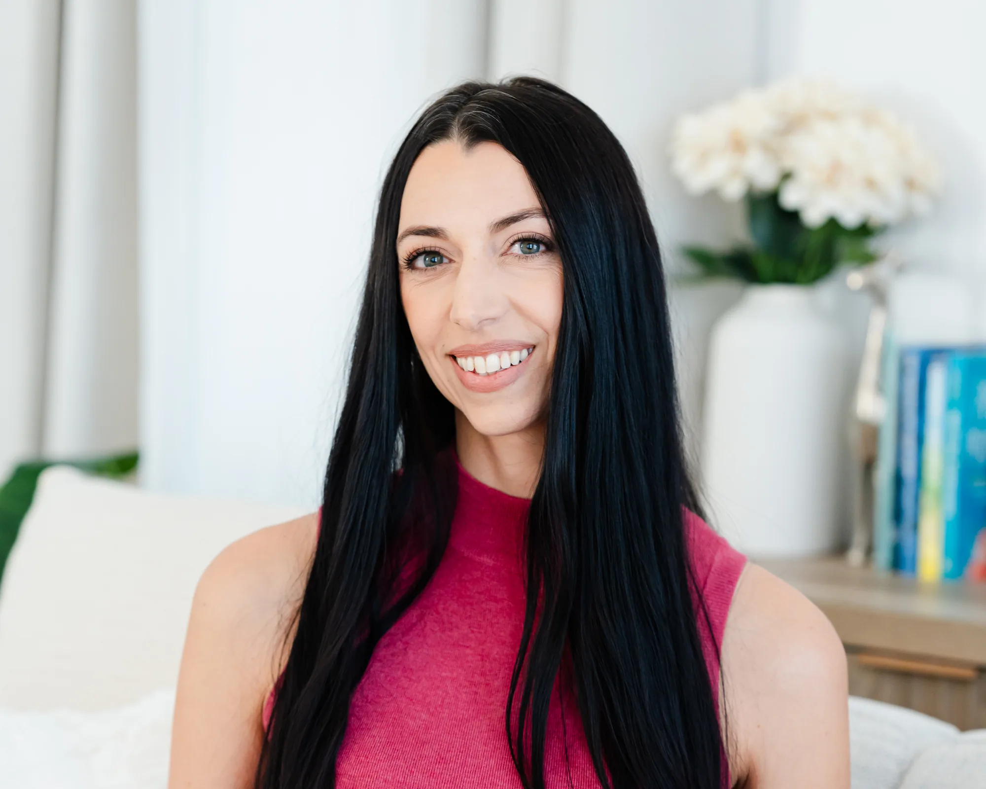 Robyn Sevigny, LMFT, seated in a bright room, smiling at the camera